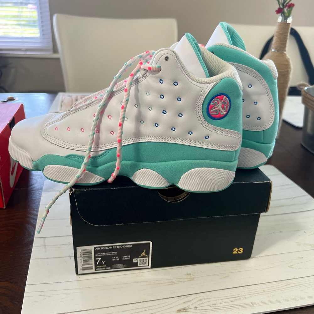 7Y shoe size but I wear 8.5 women’s.  Air Jordan Retro 13s. Teal/neon pink/white